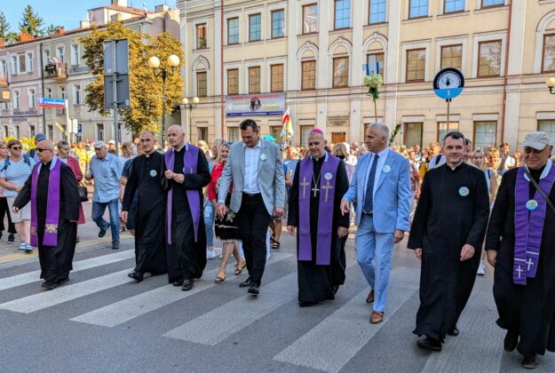 Księża i osoby świeckie idą w jednym rzędzie