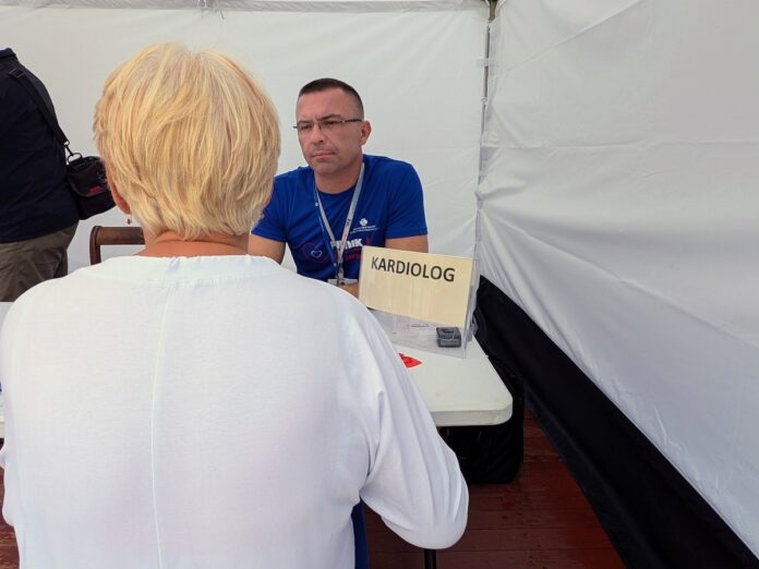 Lekarz rozmawiający z osobą pod namiotem